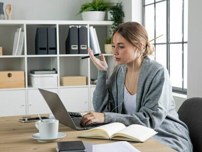 A woman managing remote work from her home office, blending professional responsibilities with energy healing to achieve a healthier work-life balance