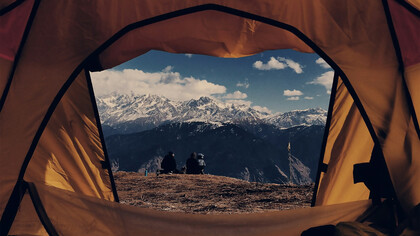 A view from a brown dome tent overlooking the Himalayas in Nepal