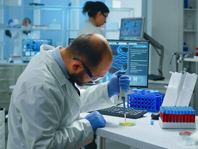 A scientist focused on microscopic investigation in a digital laboratory, symbolizing the connection between human expertise and machine intelligence