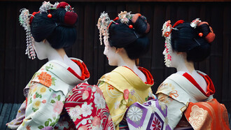 Women dressed in traditional Japanese attire: elegant kimonos with vibrant colors and intricate floral patterns are present in Japan's streets even nowadays