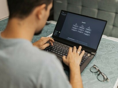 A man interacting with ChatGPT on his computer, engaging in a conversation with the AI chatbot