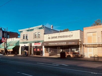 A storefront on Commercial Drive featuring  The Drive Pharmacy, Vancouver, Canada © Photo by John Macanas