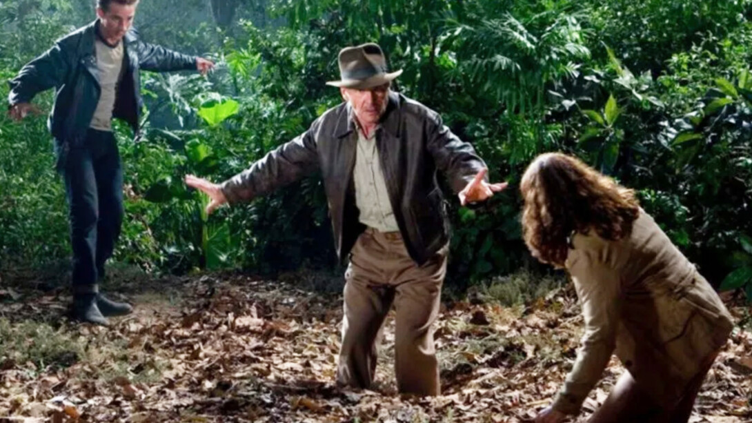 In this Indiana Jones movie, he is standing in quicksand, waving them off