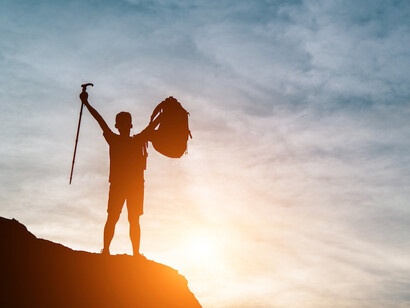 With hands raised in triumph against a breathtaking sunset, the man celebrates not just the victory, but the journey that led him to this moment of personal growth