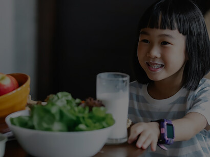 In a scene of pure bliss, a delighted young girl enjoys a refreshing glass of milk alongside a spread of wholesome, fresh delights, capturing the sheer joy of a happy, healthy mealtime