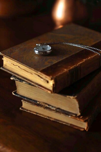 Ancient books and hand clock