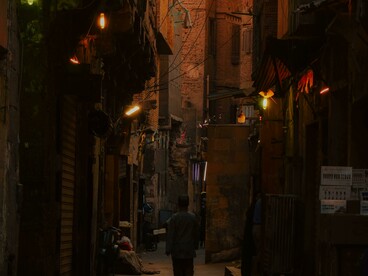 Narrow streets of old Cairo at dusk, bathed in warm, nostalgic light, Egypt