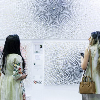 Visitors engage directly with emerging artists across vibrant exhibition booths, World Art Dubai, Dubai, United Arab Emirates