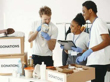 Volunteers preparing donated goods for distribution, reflecting the strength of grassroots efforts in meeting immediate needs