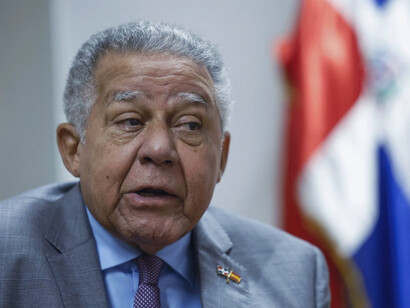 In a moment of focused deliberation, Díaz addresses critical issues, showcasing the blend of journalistic precision and diplomatic skill that continues to drive his work at the Dominican Embassy in Spain