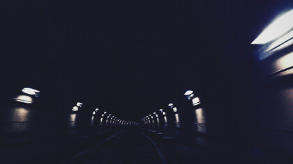 A dimly lit tunel, extending into the darkenss