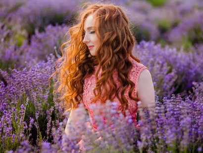 A young woman lost in the fragrant embrace of lavender