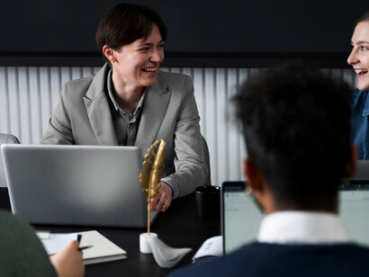 A person working alongside colleagues in an office, emphasizing the value of diverse personality types and fostering teamwork through collaboration