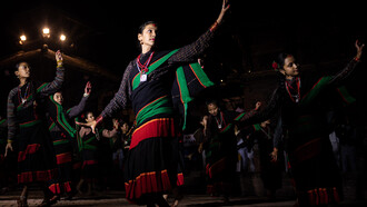 Members of the Newar community perform a traditional dance at Patan Durbar Square during the Lalit Carnival, celebrating World Tourism Day