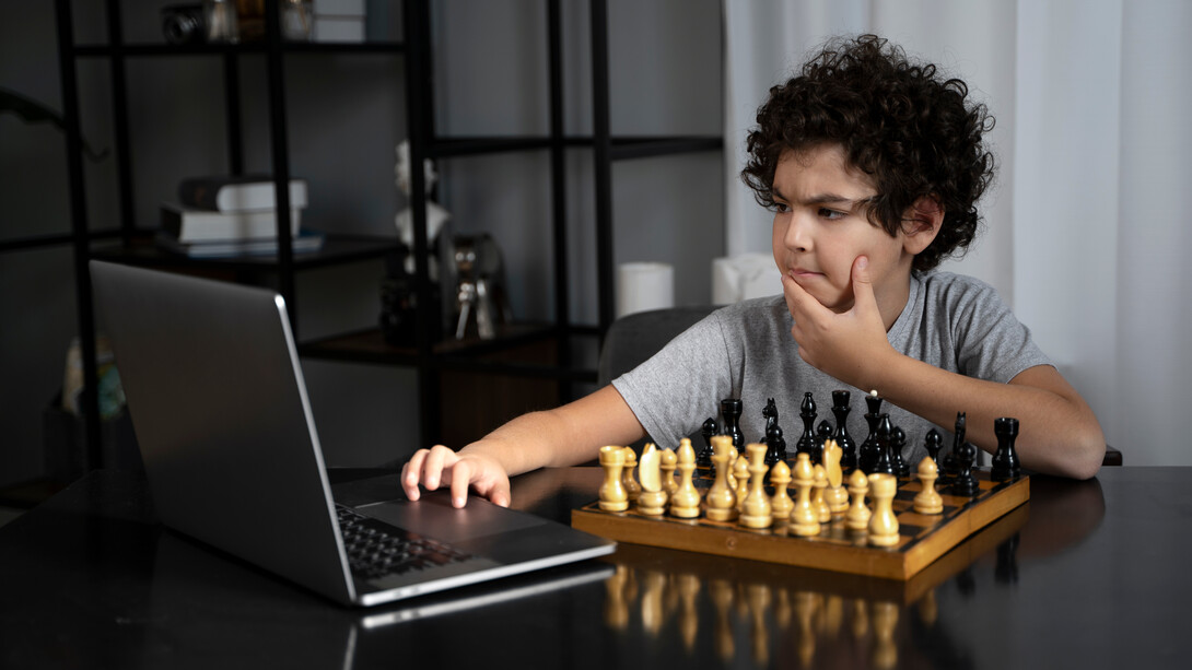 Pensive, a young chess player competes against a chess software