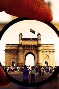 Person holding a round lens in Mumbai, India