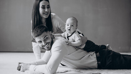 A happy family embracing the joys of parenthood with their first child