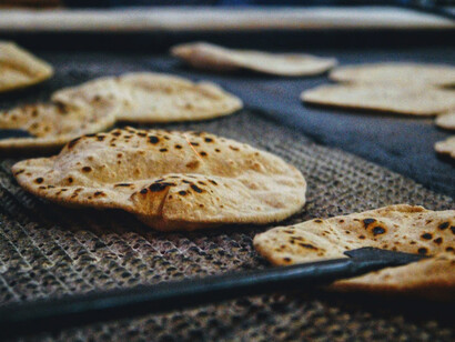 Freshly made rotis are being prepared for the langar