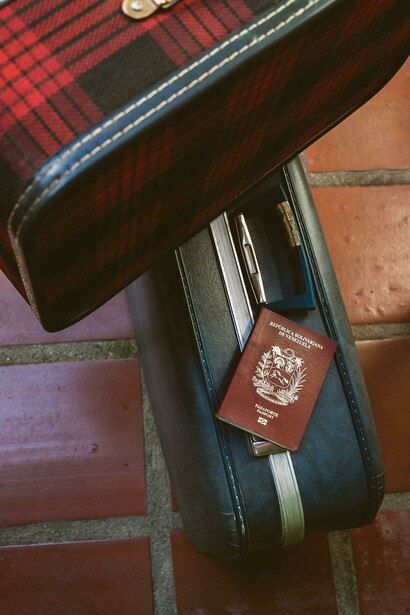 Mérida, Venezuela, a Venezuelan passport placed on a locked suitcase symbolizes the constraints of limited global mobility