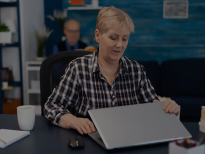 Happy senior woman engaged in computer tasks