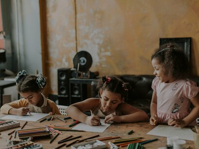 Children sat drawing at a desk