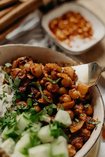 Create a quick and satisfying vegan salad by tossing together rice, chickpeas, and crunchy cucumber, resulting in a deliciously nutritious combination that's both hearty and plant-based
