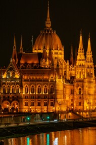 The Hungarian Parliament illuminated at night beside the Danube River, Budapest, Hungary