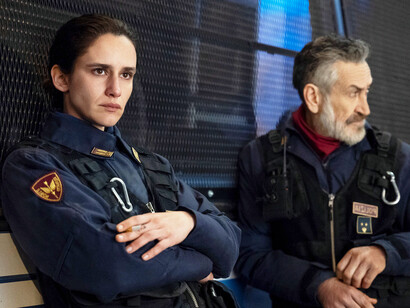 In a brief pause before the action intensifies, the officers stand united, their bond providing the only solace in a world where violence and personal pain collide