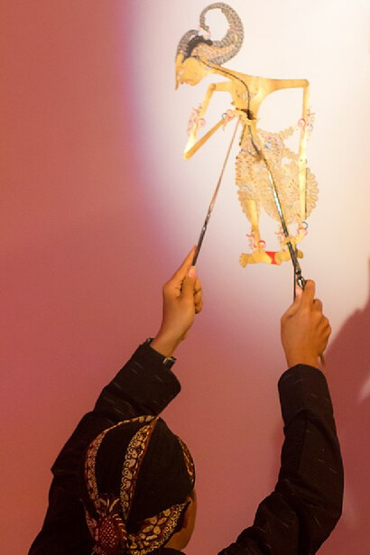 A performer engages with wayang kulit at the History of Java Museum in Yogyakarta, Indonesia 