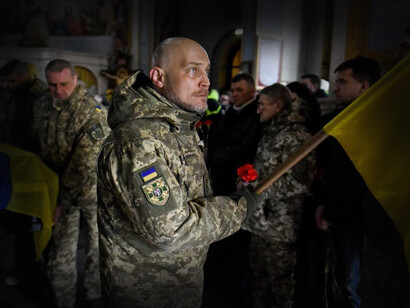 Soldados ucraniano alzan su bandera durante una ceremonia militar en la Guerra de Ucrania