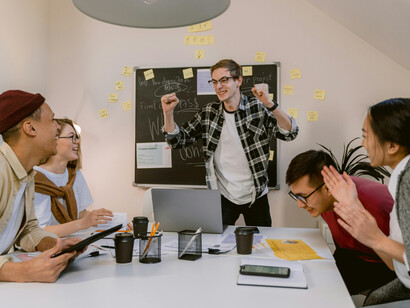 Happy people in a meeting room as young professionals brainstorm together, showing diverse team collaboration, office innovation, and creative thinking in the workplace