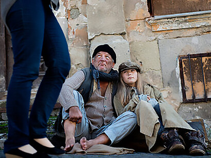 A homeless father and his daughter on the street