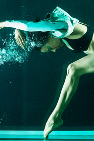 Experience the fitness revolution with a flexible woman gracefully dancing underwater—an invigorating exercise promoting holistic health and well-being