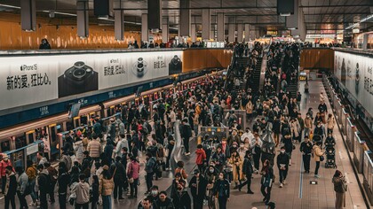 Thousands of passengers moving through a crowded transit hub, symbolizing the scale of modern urban life and the importance of accessible public transportation