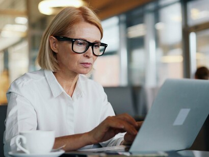 A professional focused on composing emails from a laptop, representing the human role in maintaining outbound email security
