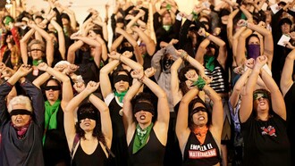 Women standing together in their cause to combat femicide in Latin America