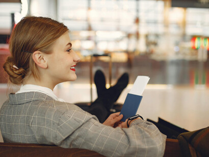Stylish young woman waiting alone in the airport terminal