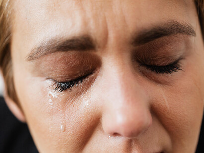 A woman cries while feeling sadness