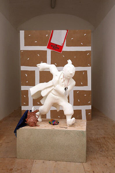 Helen Marten, The advent of a world-class economy and Untitled (every hero needs a brick wall), 2009 - 2010, Carved polystyrene, fiberglass, airline teaspoons, chipboard, shuttering ply, ceramic, ballchain, fabric, painted MDF, castor wheels, printed felt poster, Base: 40 x 90 x 65 cm; figure: 90 x 70 x 40 cm, Courtesy of the artist