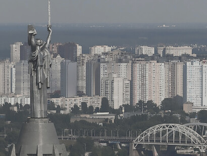 In Kyiv, Ukraine, a commanding statue depicting a soldier gripping a shield stands as a compelling focal point, offering a powerful and evocative scene