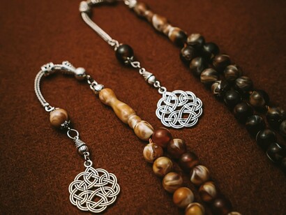 Handcrafted prayer beads with natural materials, reflecting strong personal devotion and cultural practice