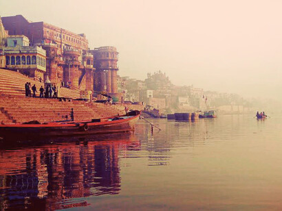 As the sun rose, the facades of temples and buildings that lined the ghats reflected the first rays of light, Varanasi, India