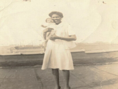 The author Martha Bireda, as a baby, being held by a happy mum