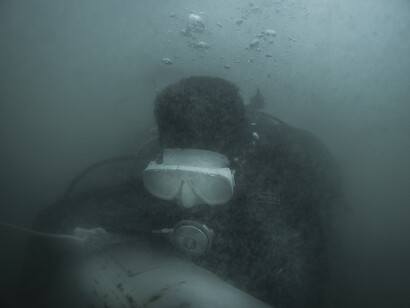 UXO salvage diver Leng Channak (33) takes part in the training
programme devised by the USA 7th Engineer Dive Detachment off the
coast of Sihanoukville, Cambodia. The divers train to identify UXO
(inert for training purposes) wearing ‘black-out’ masks to simulate the
zero visibility they will encounter in the rivers and lakes of Cambodia