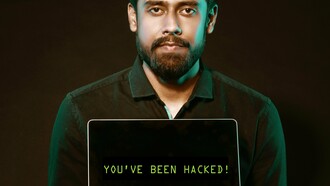 Man with a laptop suggesting that 'you have been hacked'