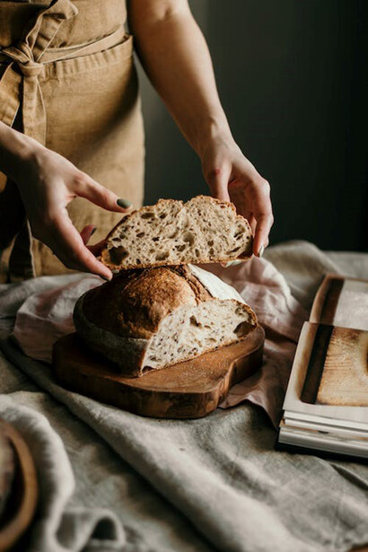 Woman sliced freshly baked sourdough bread