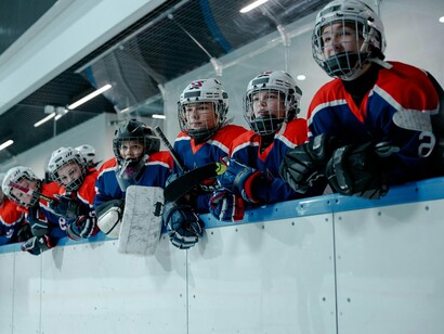 A youth ice hockey team gathered in the stands, representing the early stages of competitive ambition