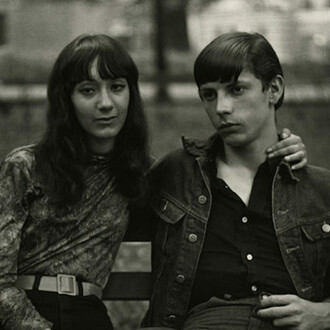 Diane Arbus, Young Couple on a Bench in Washington Square Park, N.Y.C., 1965, Gelatin siver print, Framed: 24 1/2 x 24 1/2 inches (62.2 x 62.2 cm). Courtesy of David Zwirner

