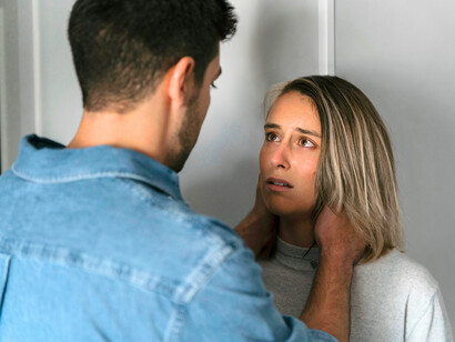 A mother overcome with grief as her partner supports her, conveying the desperate need for reassurance in the face of loss