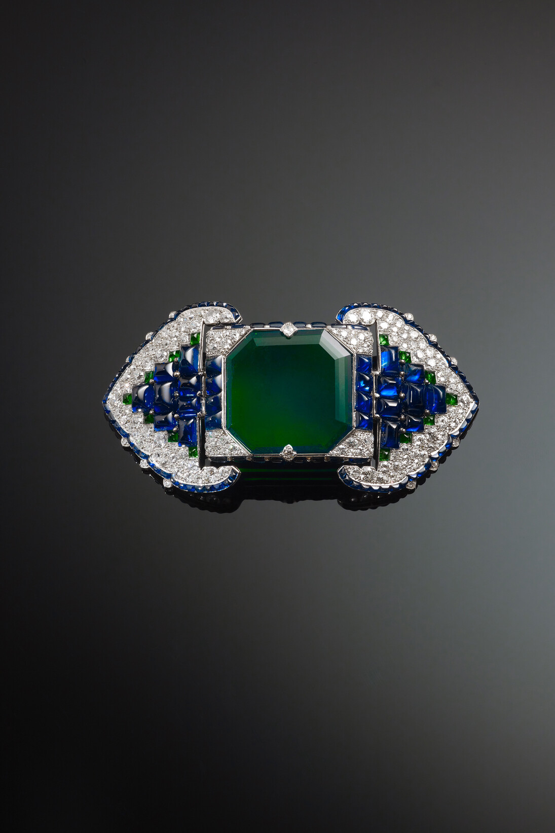 Brooch set with emeralds, sapphires and diamonds, 1922, By Cartier, Paris, France, The Al Thani Collection © Servette Overseas Limited, 2014. Photograph: Prudence Cuming Associates Ltd